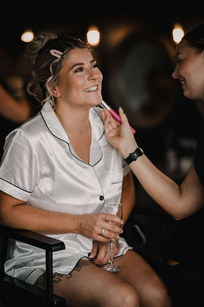 Bride laughing during her wedding morning makeup